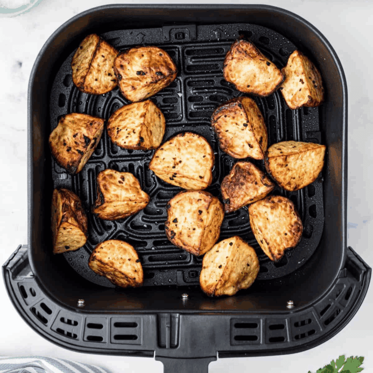 Crispy, golden Air Fryer red potatoes seasoned with garlic, olive oil, salt, and pepper.