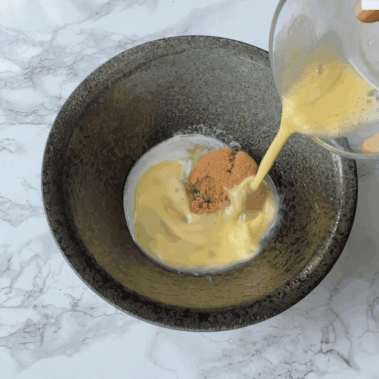 Step-by-step process for making Copycat Otis Spunkmeyer Chocolate Chip Cookies: preheating oven, lining baking sheet, creaming butter with sugars, and mixing in eggs and vanilla extract.