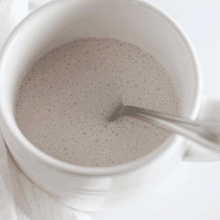 Mug being filled with angel food cake batter, ¾ full for rising