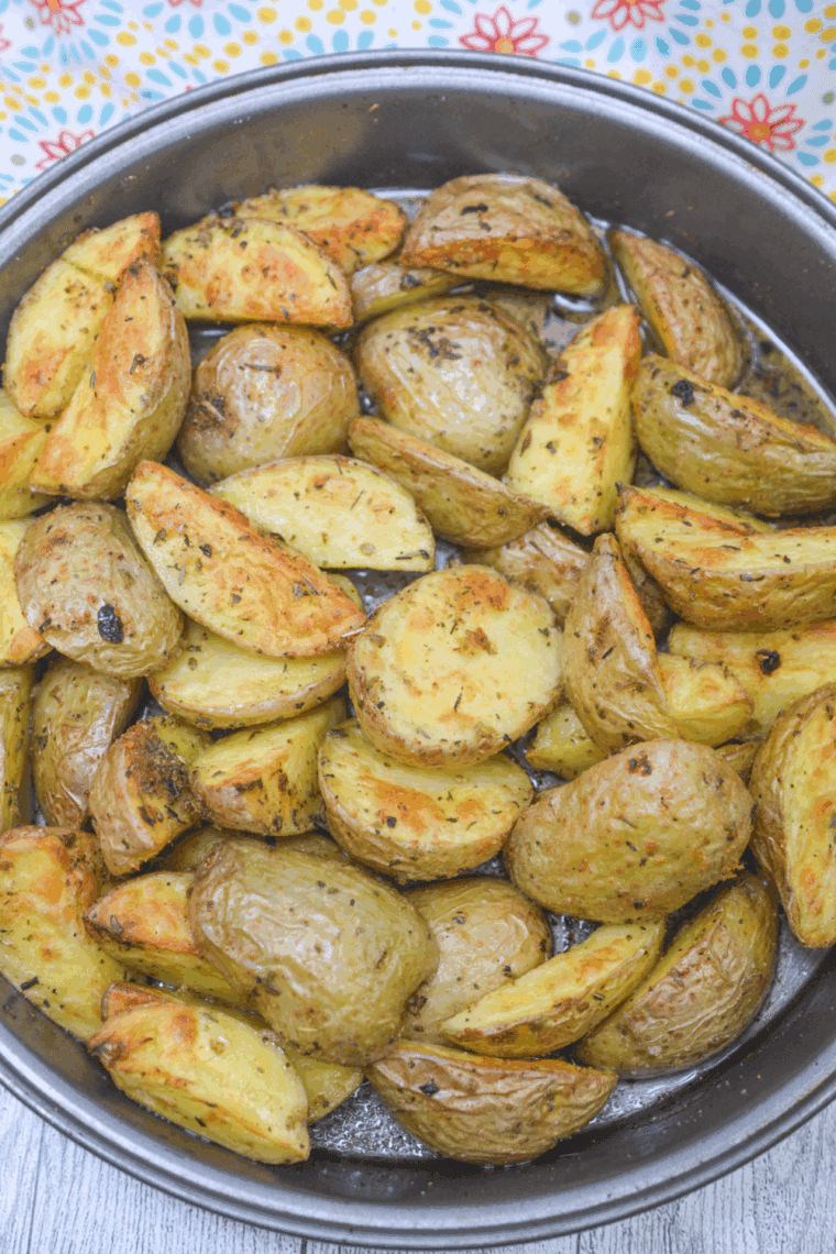 Extra crispy air fryer loaded baby potatoes, seasoned and golden brown, served with optional parsley and Parmesan.