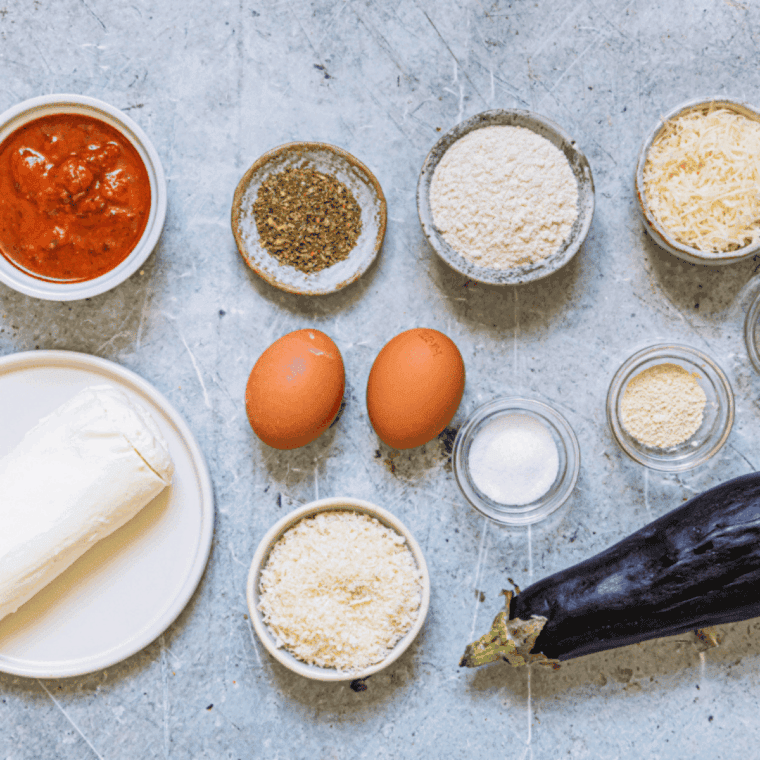 Laying the ingredients needed for Easy Cheesecake Factory Eggplant Parmesan Recipe on kitchen table.