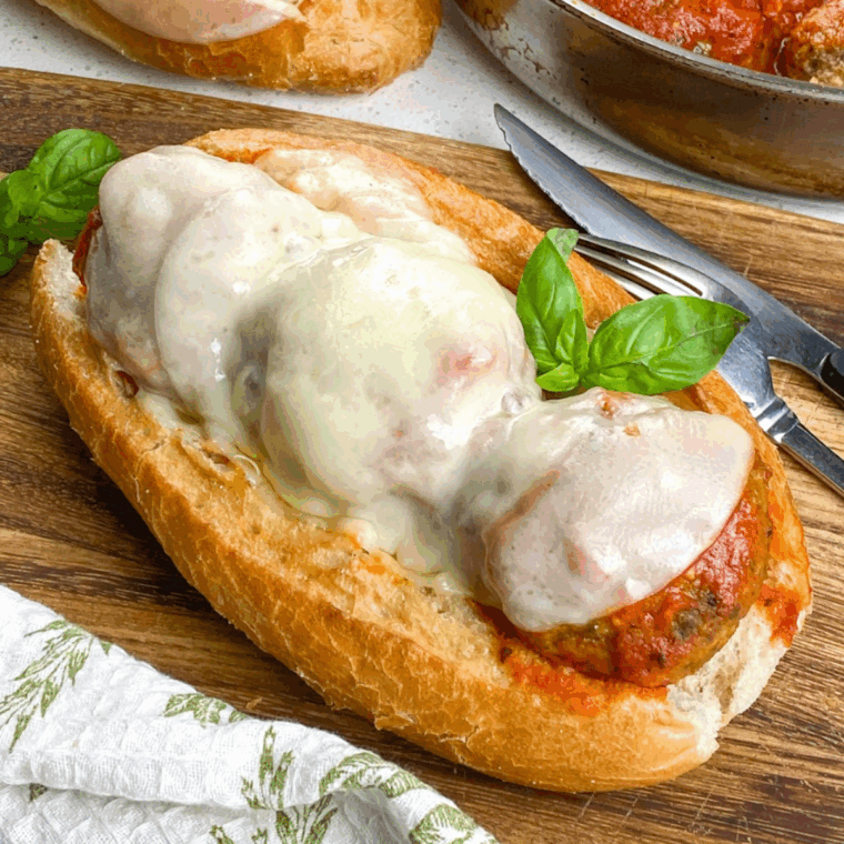 Juicy meatball sub with marinara sauce and melted cheese on a soft hoagie roll, ready to eat.