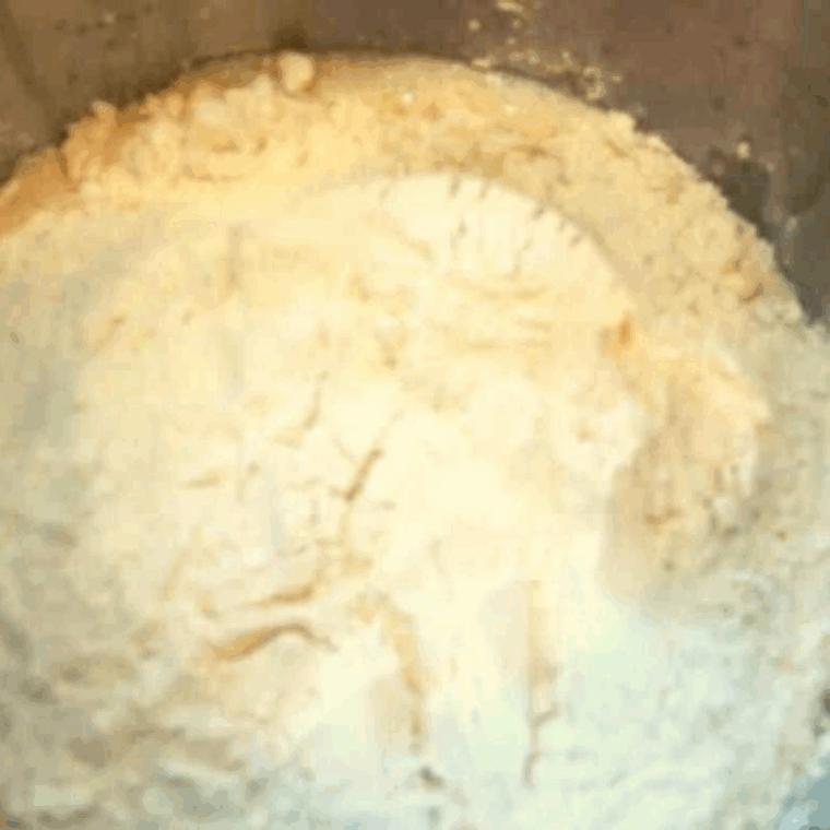 flour, melted butter, and salt added to yeast mixture and combined in bowl