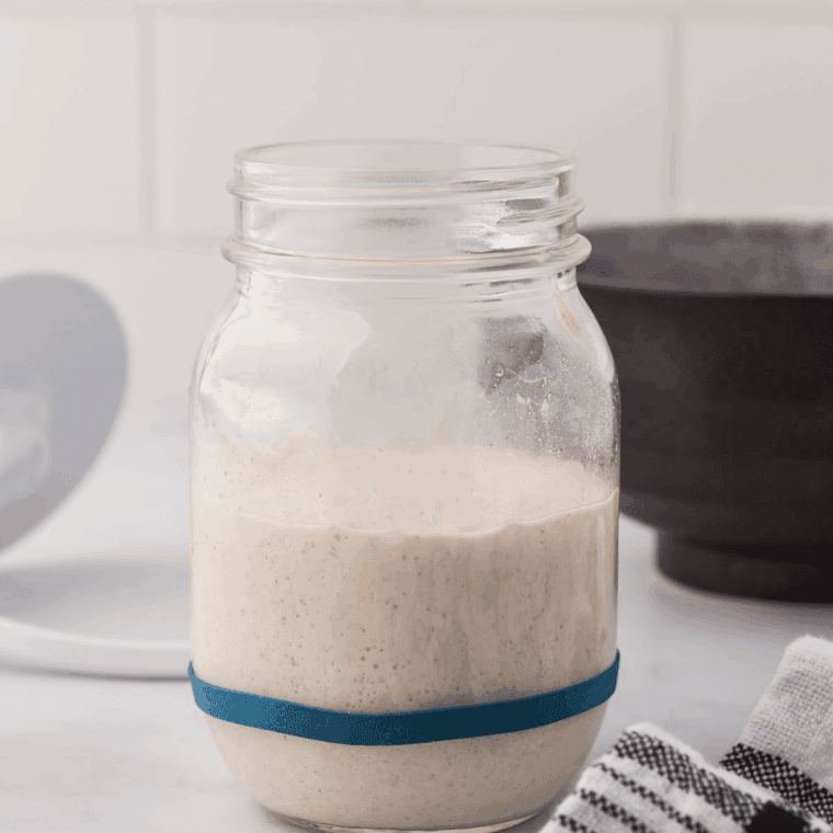 Mixing sourdough discard, flour, milk, butter, sugar, salt, and yeast into sticky dough in a large bowl