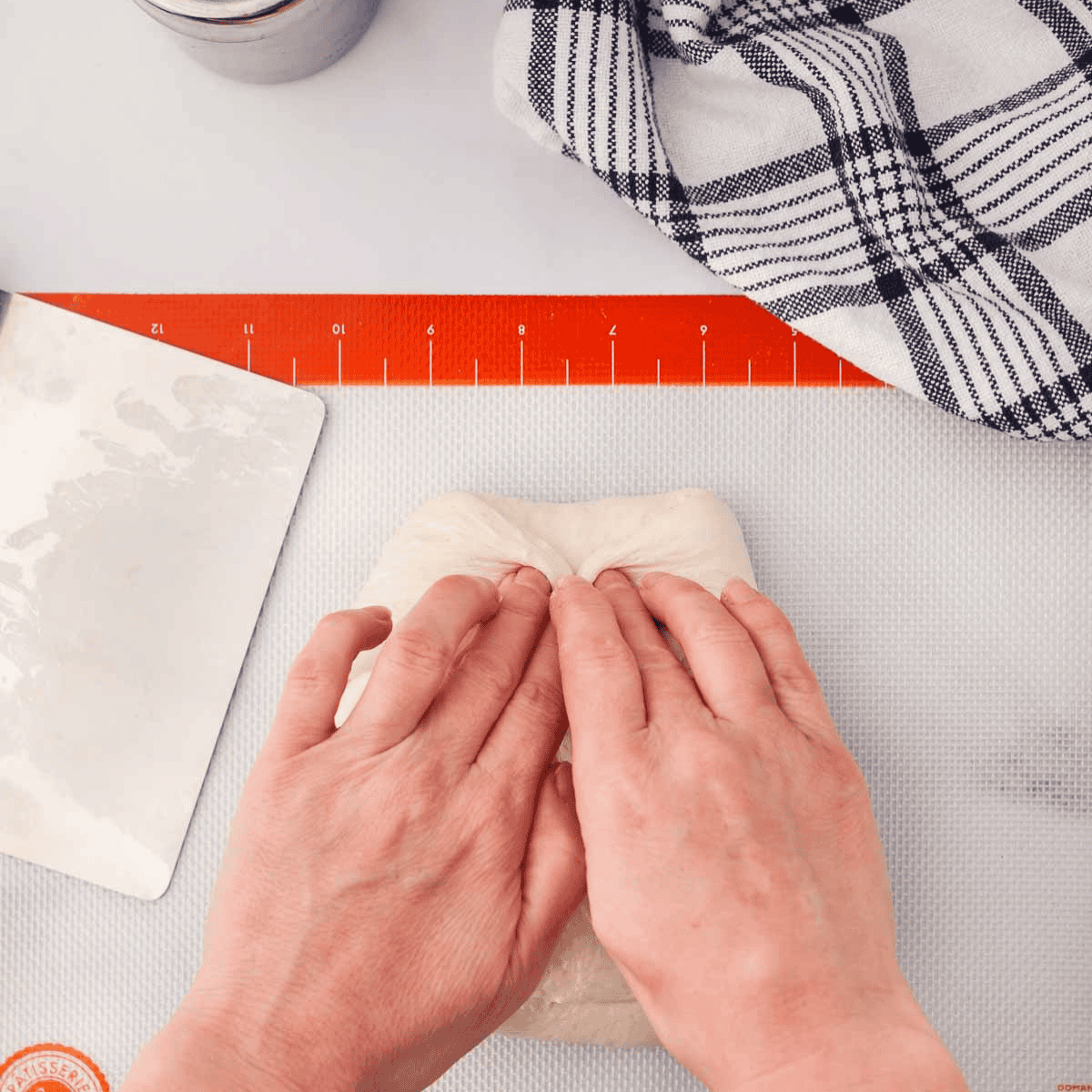 Sourdough rolls covered with towel, rising in warm spot until puffed and doubled