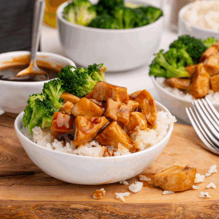Bowl of fluffy Greek rice garnished with herbs and lemon slices