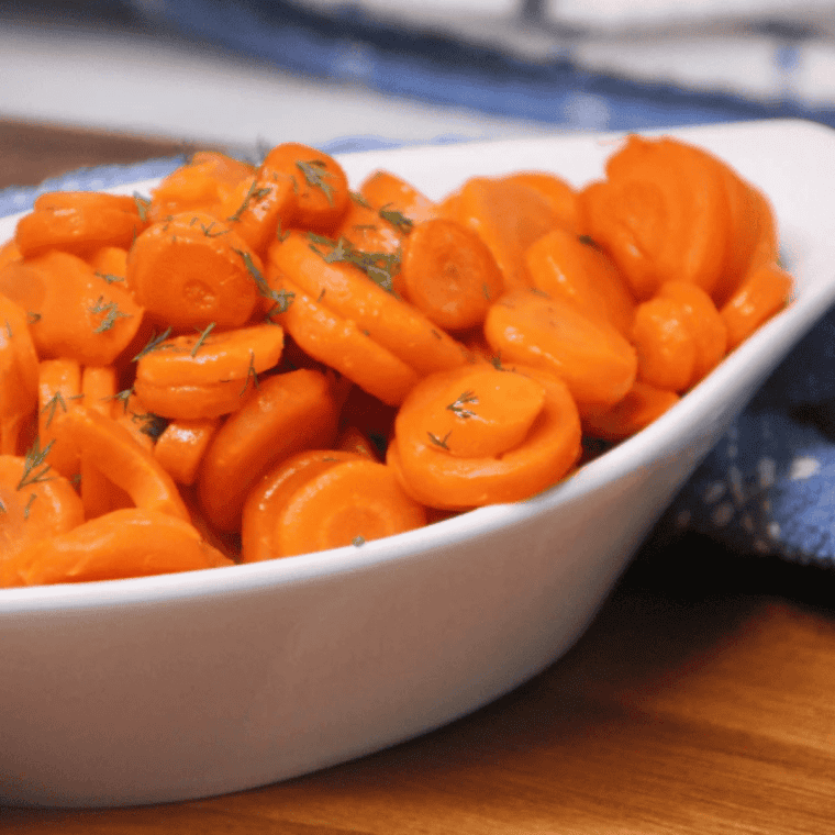 Golden, tender canned carrots cooked in an air fryer, served in a bowl.