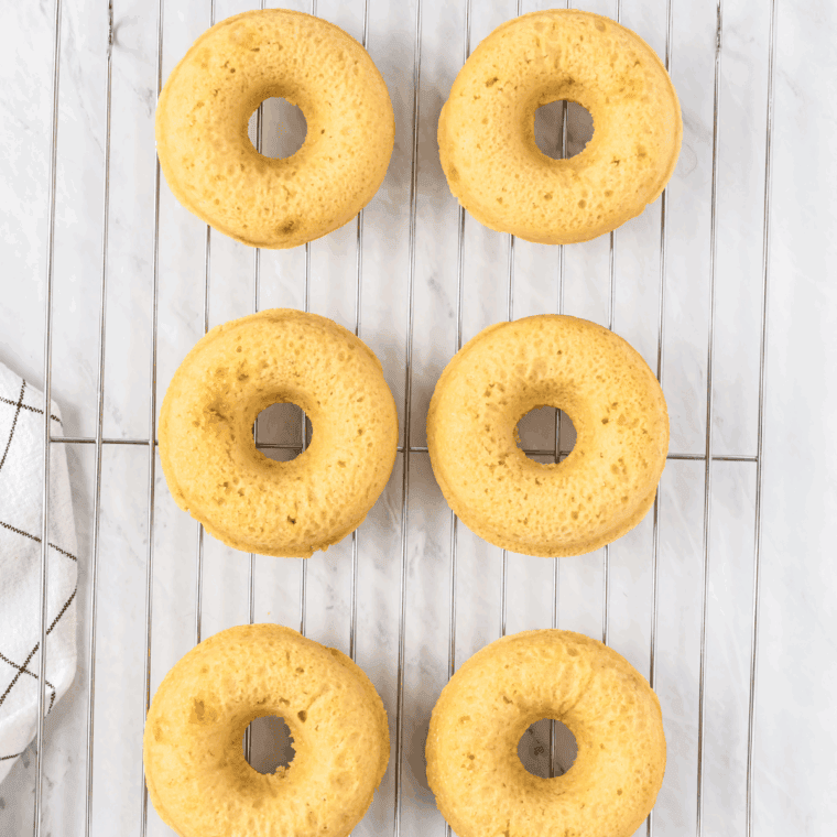 Donut pan placed in air fryer at 320°F, baked until springy, then turned onto wire rack to cool.