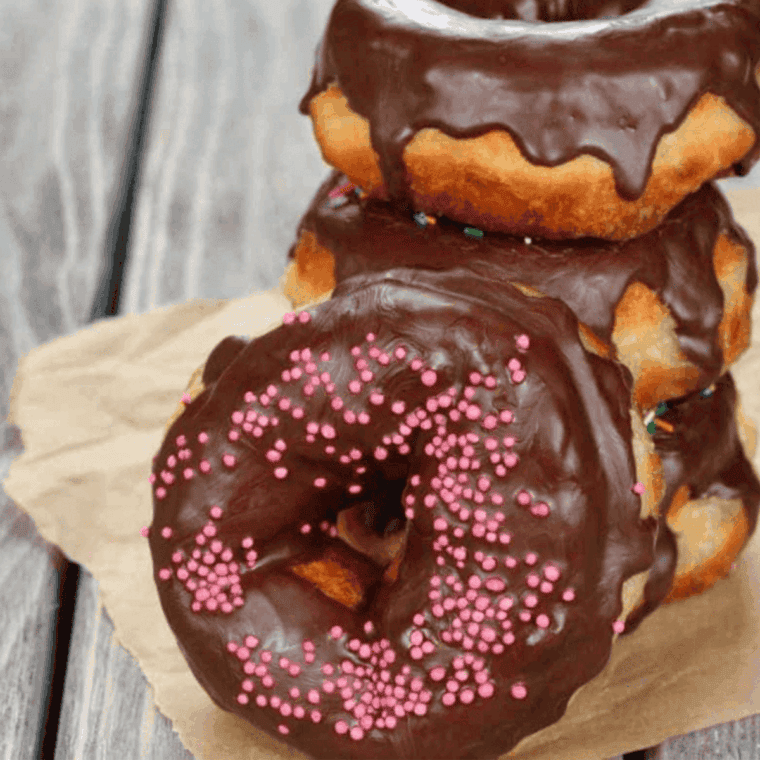 Air Fryer Nutella Donuts topped with powdered sugar, golden and fluffy, with creamy Nutella inside.