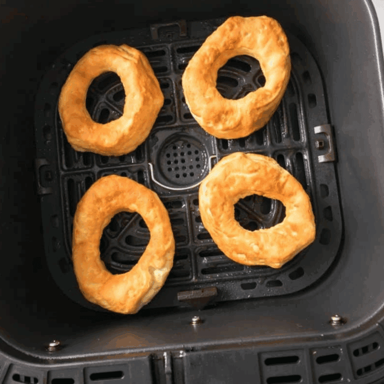 Cooked Nutella donuts in the air fryer basket.