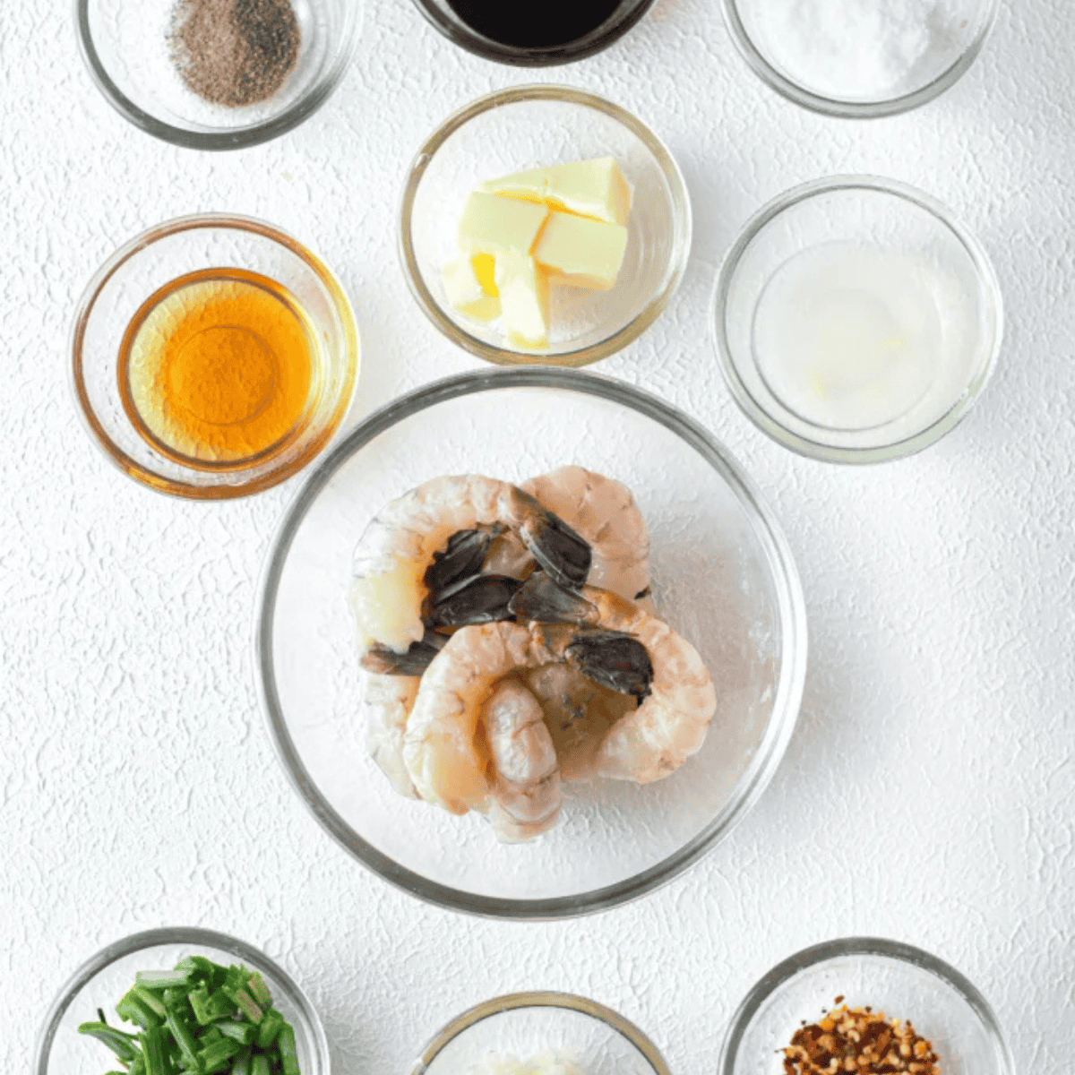Ingredients for air fryer Old Bay shrimp skewers &mdash; raw shrimp, Old Bay seasoning, olive oil, lemon, garlic, and wooden skewers