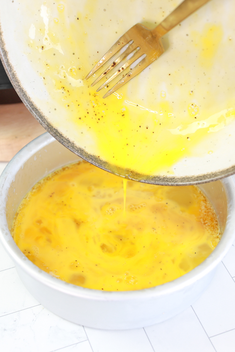 egg mixture fully blended in bowl with no streaks before cooking.