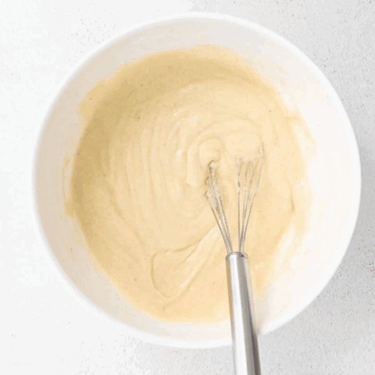Mixing egg, milk, vegetable oil, and vanilla into dry ingredients until smooth.