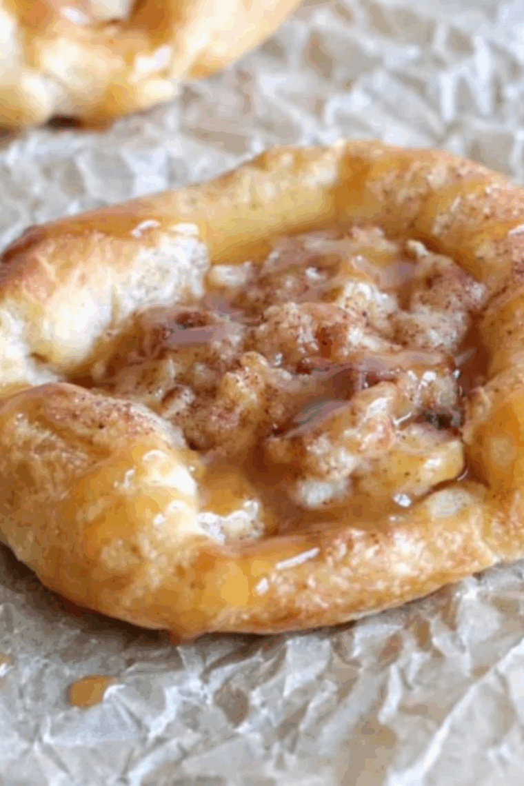 Golden, flaky apple Danish fresh from the air fryer, filled with cinnamon-spiced apple and drizzled with caramel.