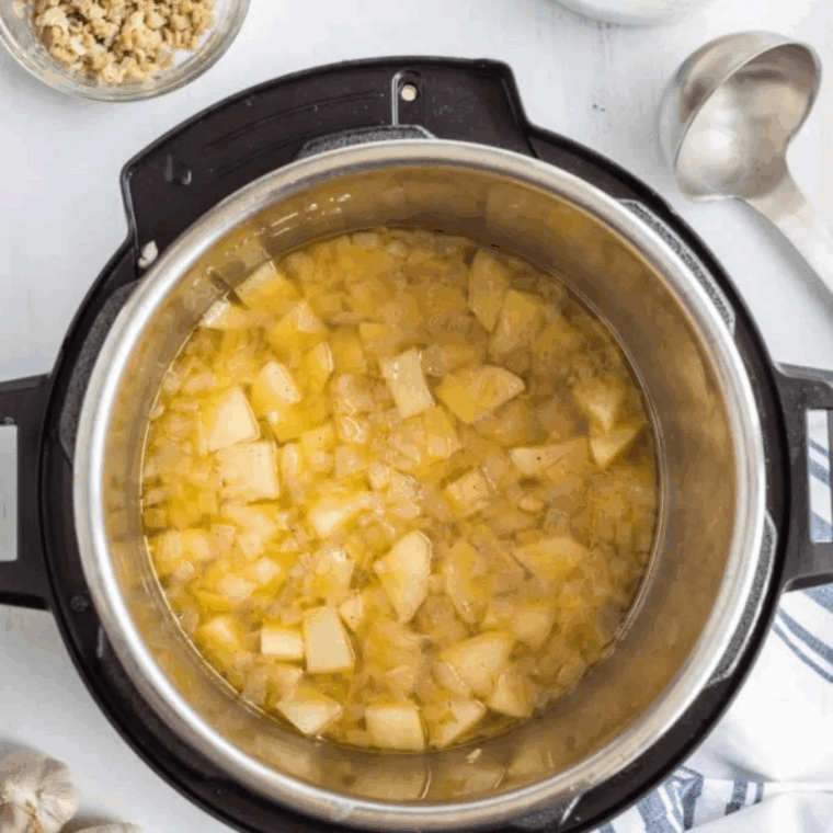 Adding cubed potatoes, clam juice, canned clams, bay leaves, and thyme to the Instant Pot before sealing the lid and setting it to pressure cook.