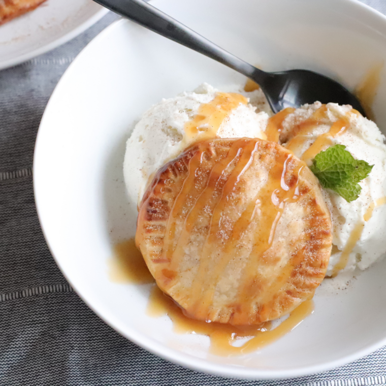 Air Fryer Caramel Apple Hand Pies plated with a scoop of vanilla ice cream