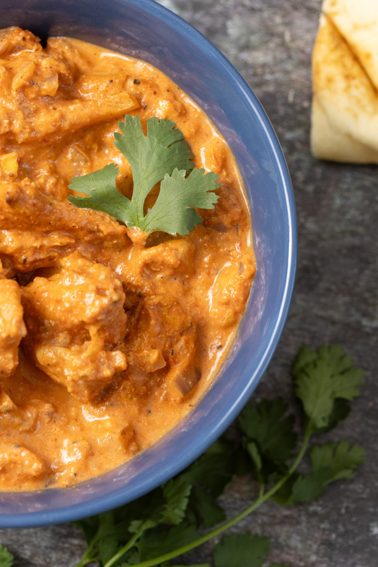 Air Fryer Chicken Tikka Rice Bowl with juicy spiced chicken, fluffy rice, colorful vegetables, and fresh herb garnish