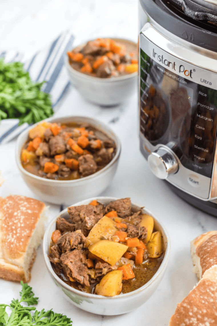 Copycat Panera Bread beef stew with tender beef, carrots, and potatoes in a rich broth, served in a bowl with crusty bread