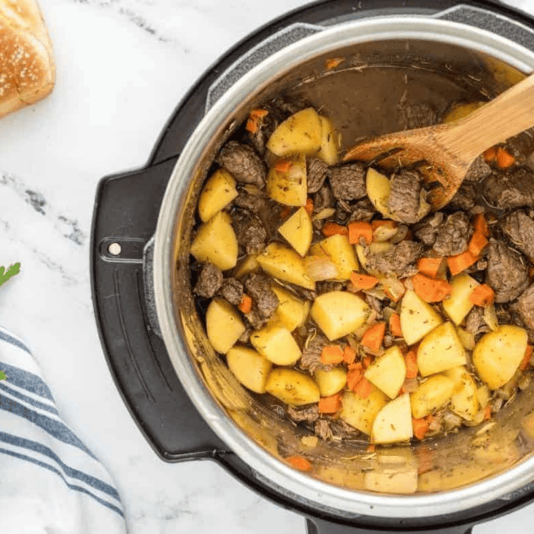 Beef, potatoes, butternut squash, green beans, and broth in the Instant Pot before pressure cooking