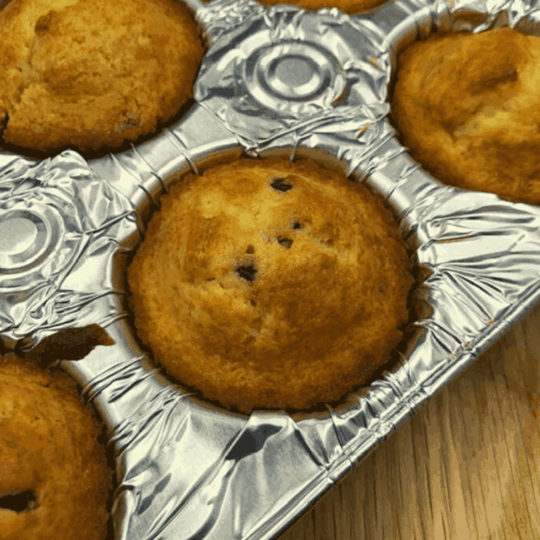 Golden air fryer chocolate chip muffins made from Betty Crocker mix, with melty chocolate chips and soft, fluffy centers, freshly baked and ready to enjoy.
