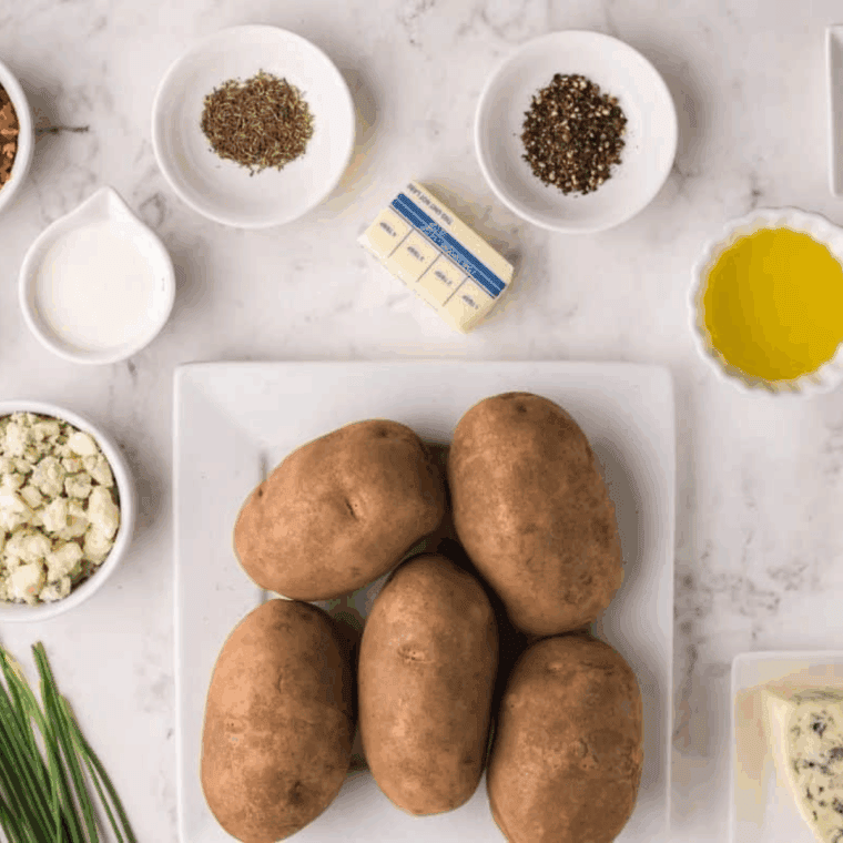 Ingredients needed for Air Fryer Hasselback Bacon and Bleu Cheese Potatoes on kitchen table.