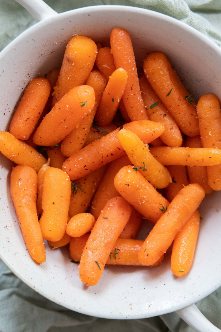 Spoon the carrots and glaze into a serving bowl, sprinkle with parsley, and serve warm.