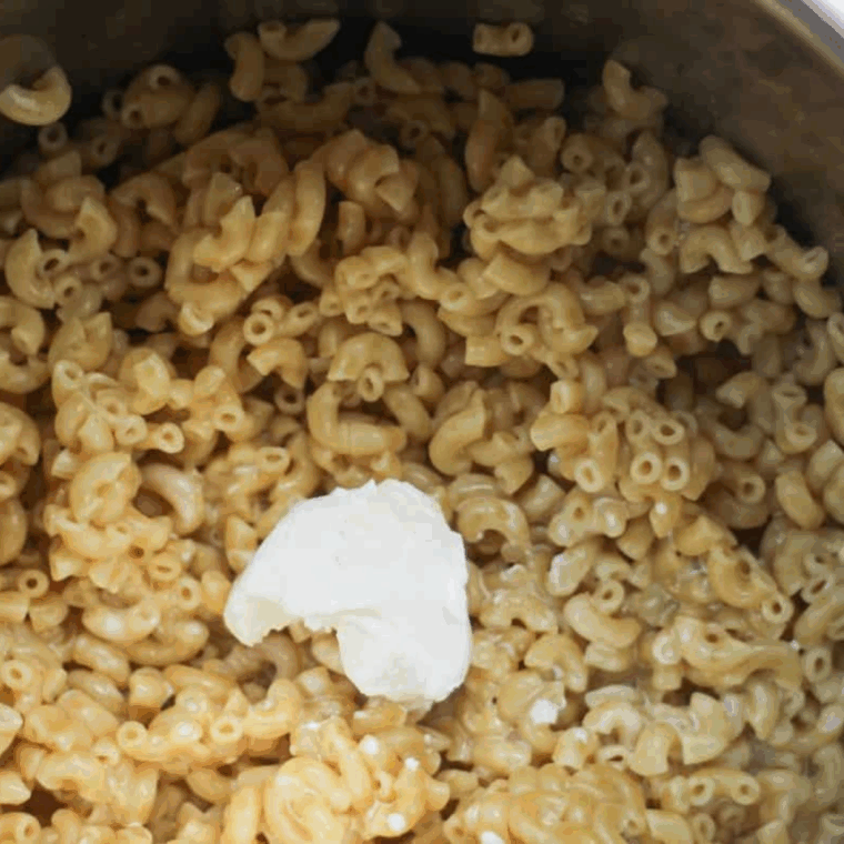 Add the cheeses to the macaroni and cheese.