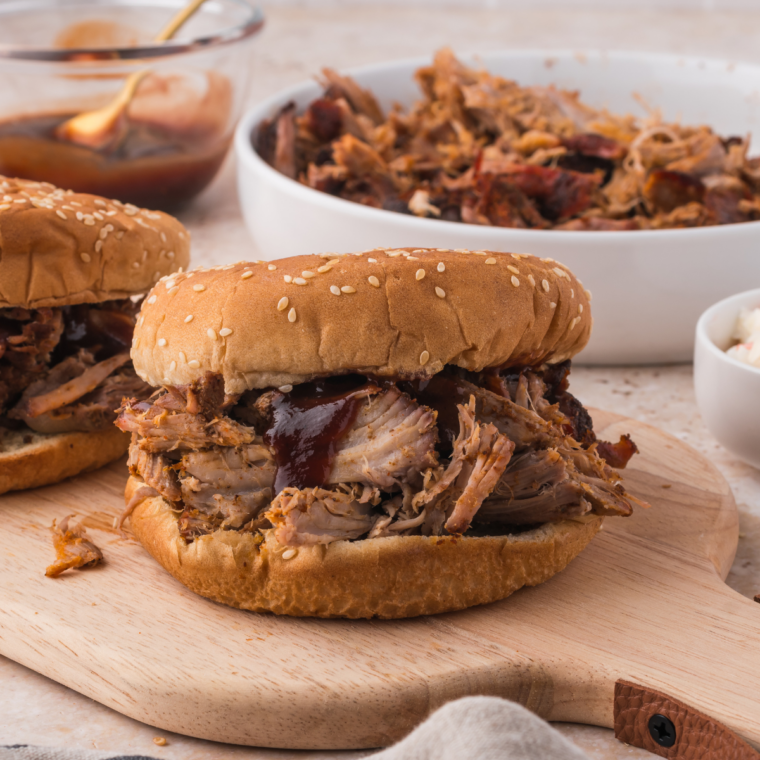 Mission BBQ pulled pork sandwich with coleslaw and barbecue sauces on the side