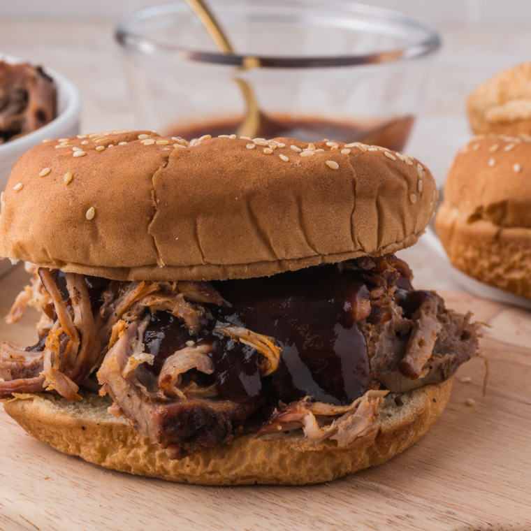 Copycat Mission BBQ pulled pork piled high on a toasted brioche bun with coleslaw and barbecue sauce