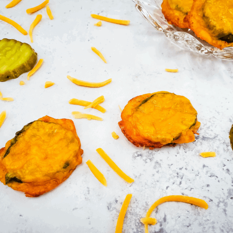 Crispy air fryer cheese pickles with shredded cheddar and tangy dill pickle chips, golden and ready to serve.