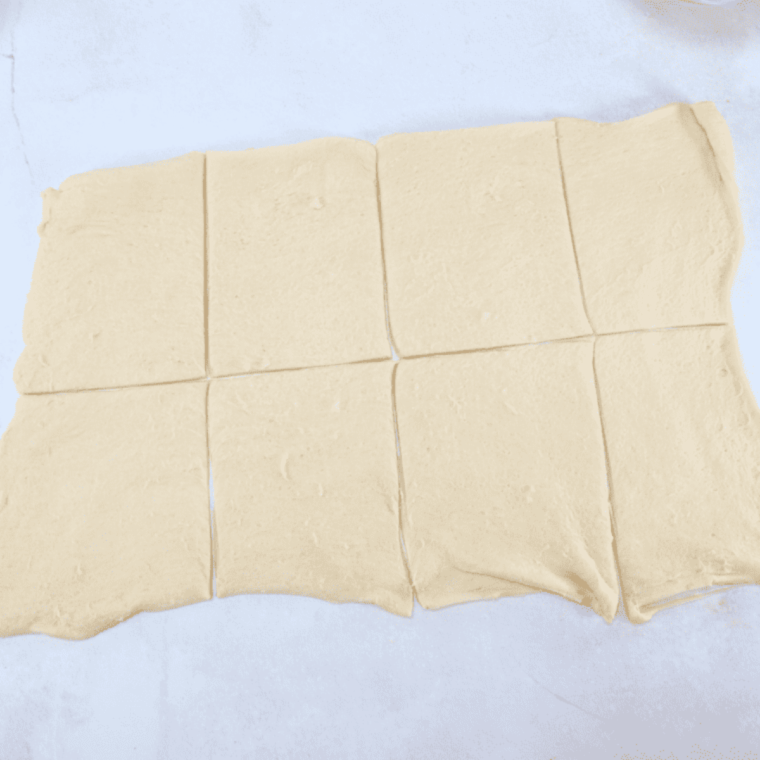Crescent dough sheets cut into eight equal pieces using a pizza cutter
