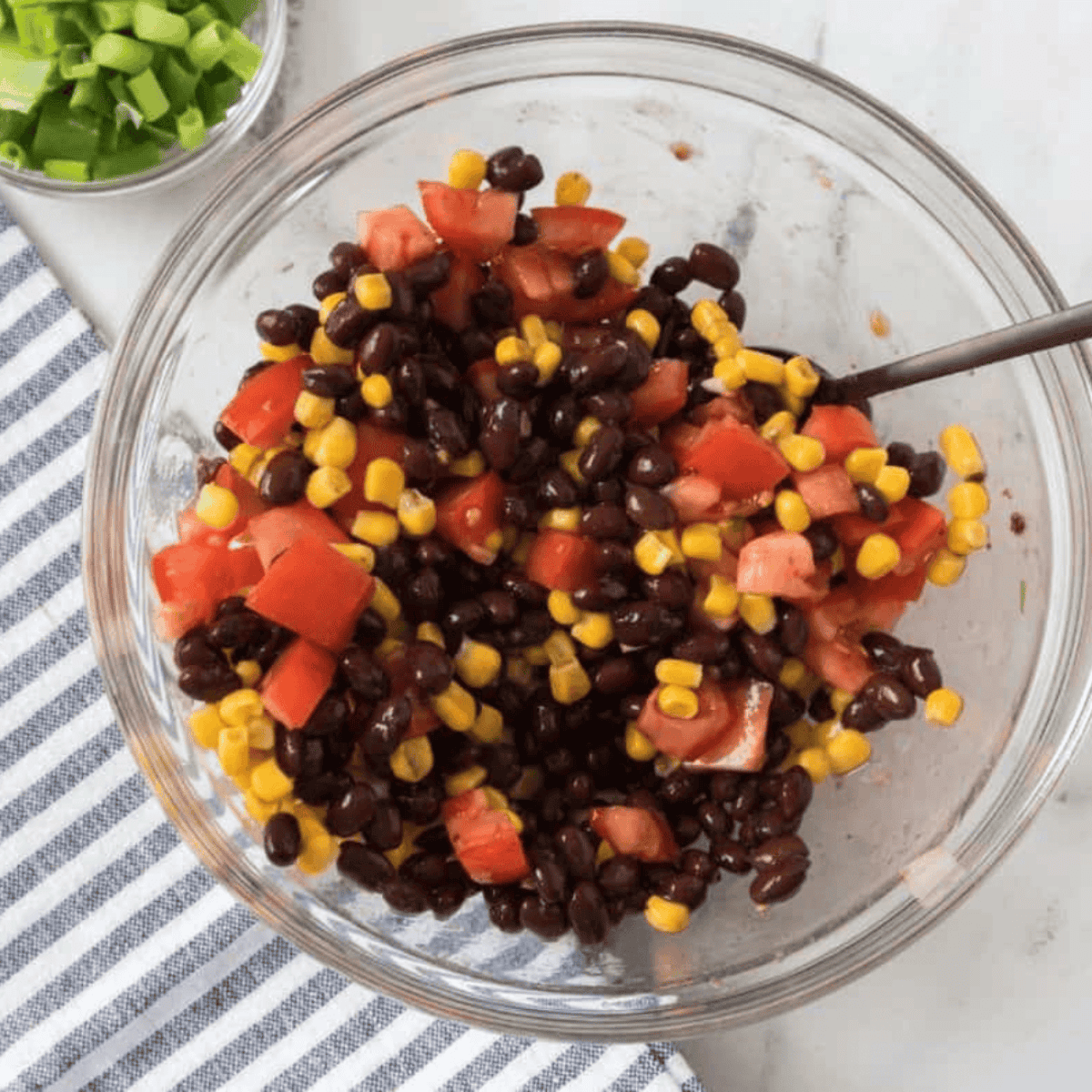 Mini sweet peppers filled with a mixture of corn, black beans, tomatoes, and sprinkled with cheese.
