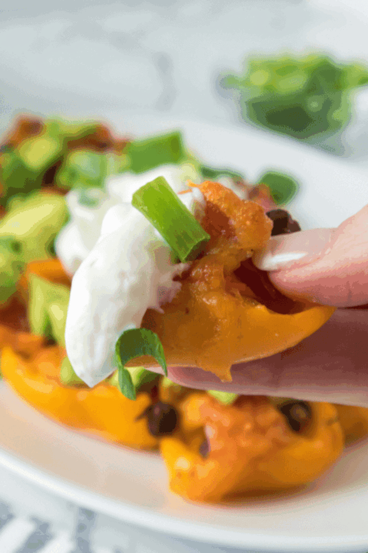 Air fryer mini pepper nachos with melted cheese, corn, black beans, avocado, and green onions