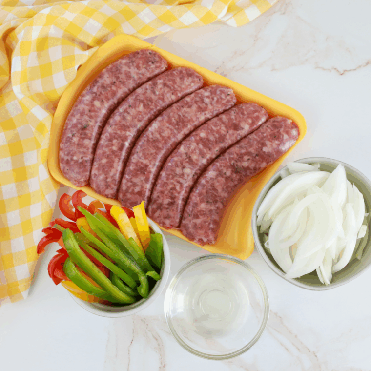 Ingredients needed for Easy Air Fryer Sausage, Peppers, and Onions on kitchen table.