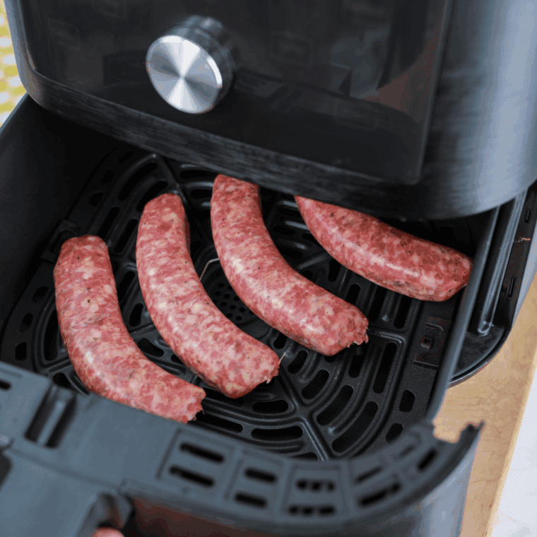 Sausage in the air fryer basket.