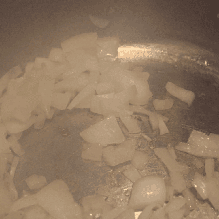 Instant Pot sautéing onions and garlic in olive oil for collard greens base.