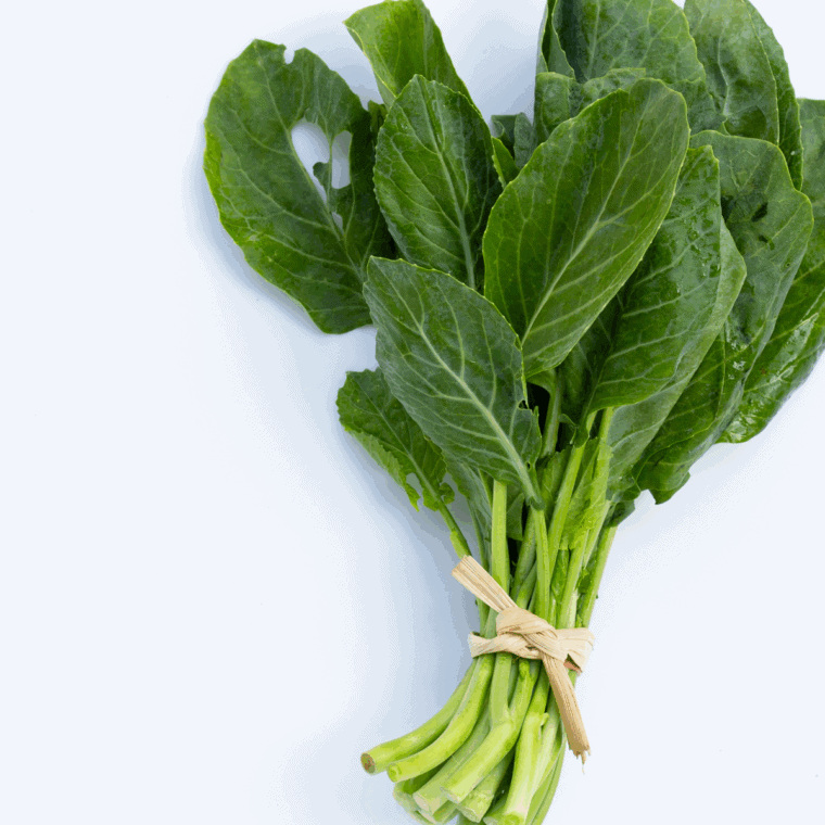 Ingredients needed for Easy Golden Corral Collard Greens Recipe on kitchen table.