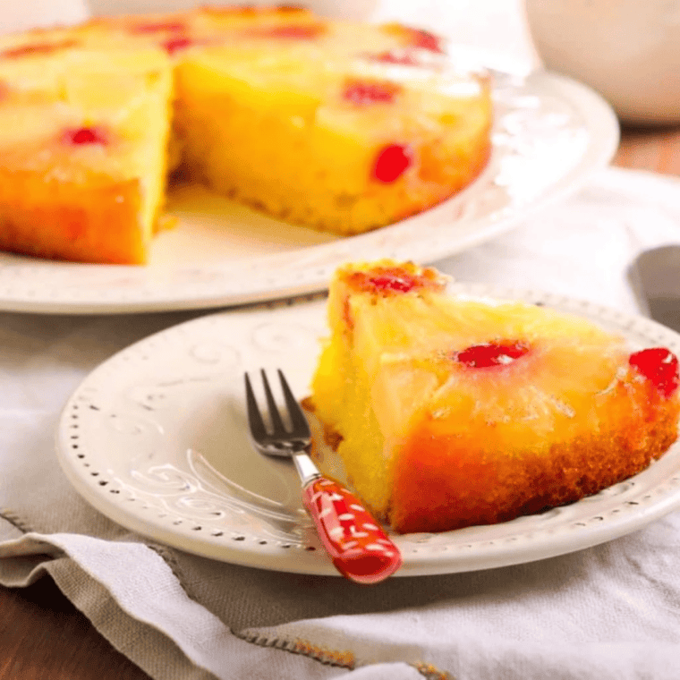 Sliced pineapple upside down cake served on plate, ready to enjoy.