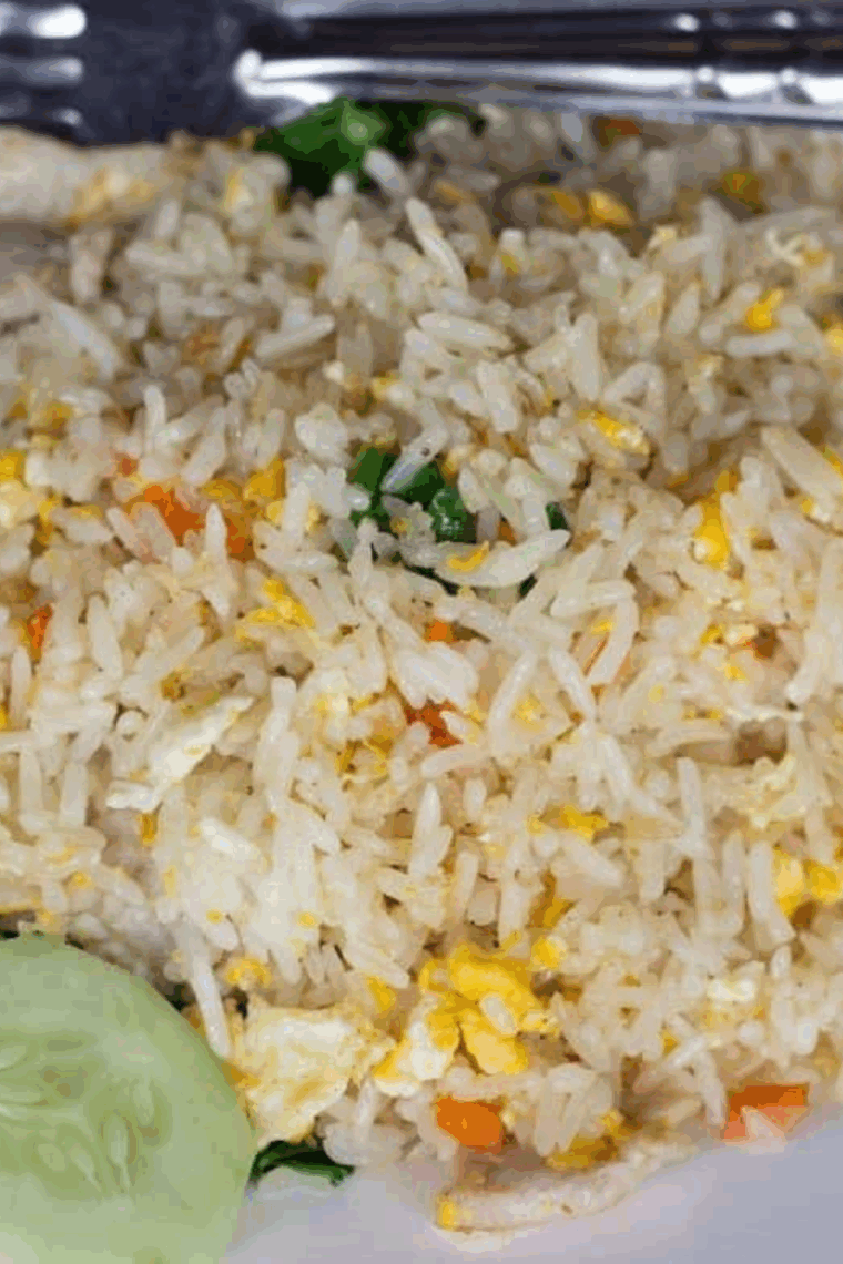 Fluffy pork fried rice garnished with green onions and vegetables