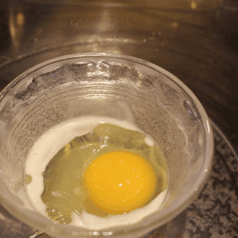 Crack the egg into a ramekin.