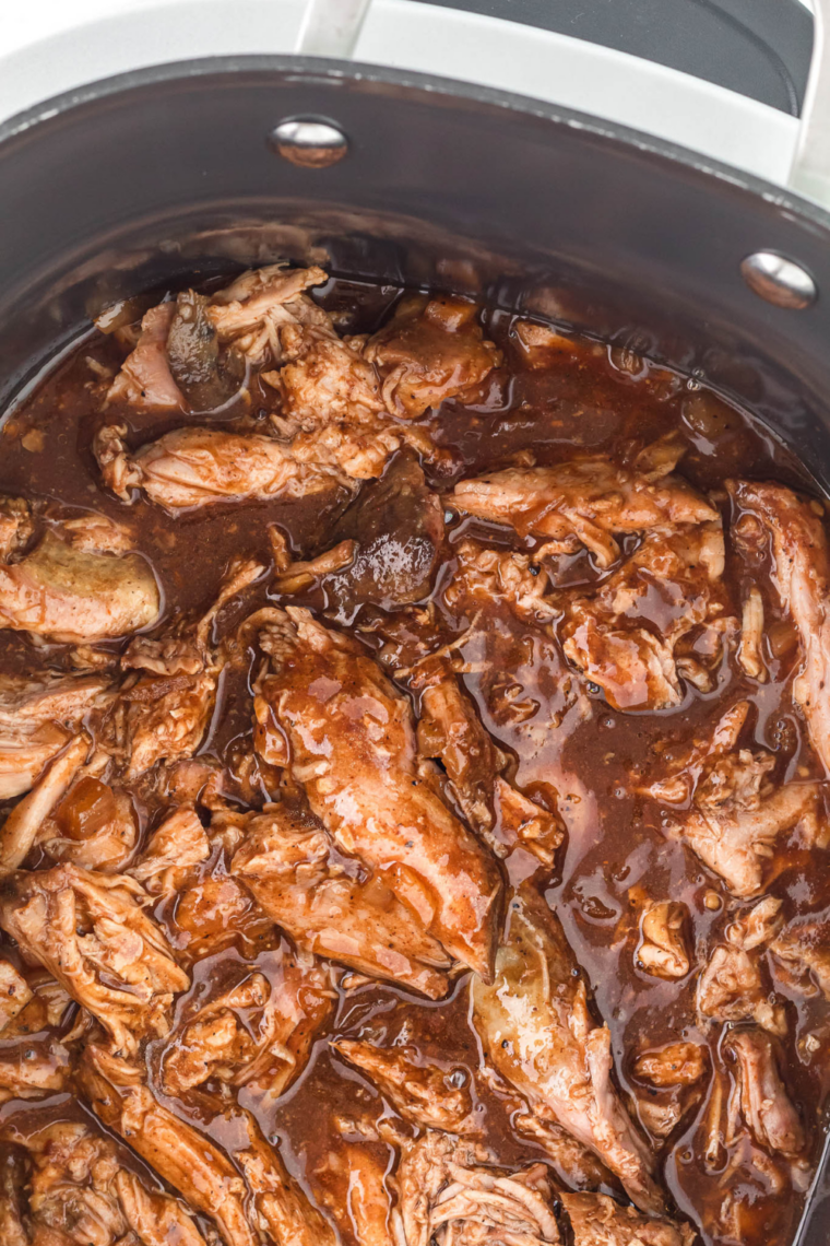 Mission BBQ copycat pulled chicken served with bowls of BBQ sauce on the side