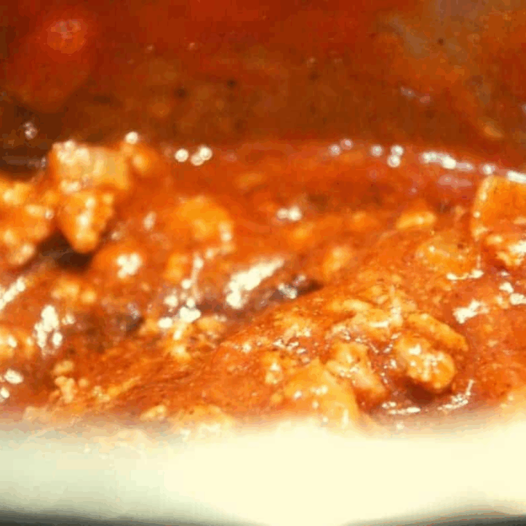 Add ketchup, BBQ sauce, and ancho chili powder to browned meat in Instant Pot, then cook under high pressure for 10 minutes with lid on.