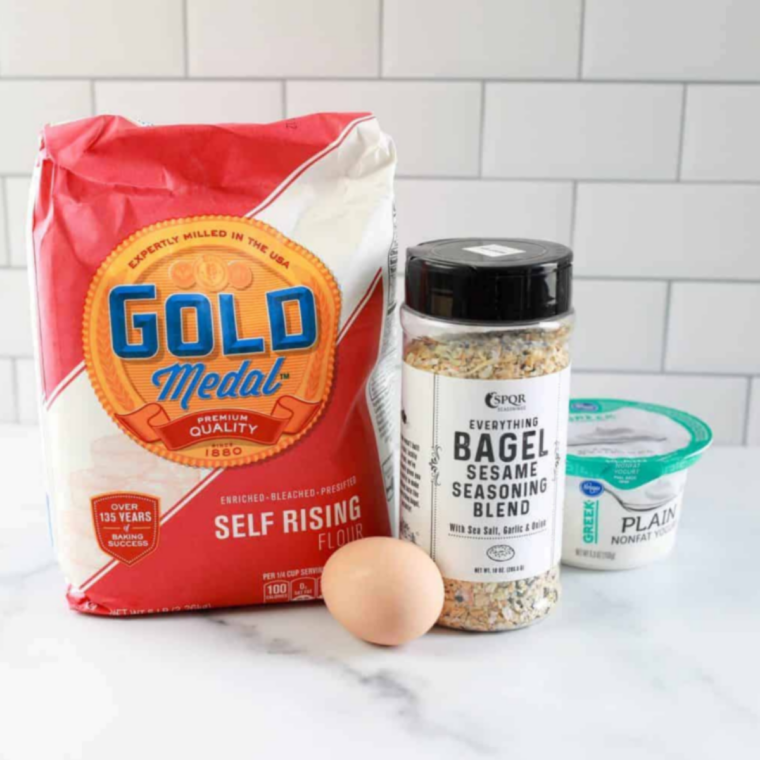 Ingredients for 2-ingredient air fryer everything bagels: self-rising flour, Greek yogurt, egg, and everything bagel seasoning