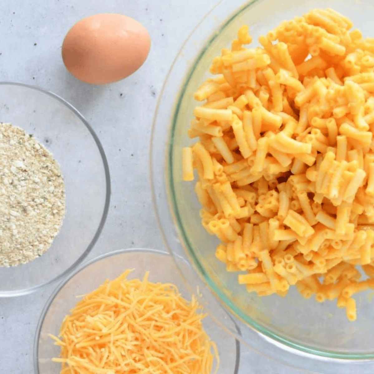 Ingredients needed for Air Fryer Macaroni and Cheese Muffins on kitchen table.