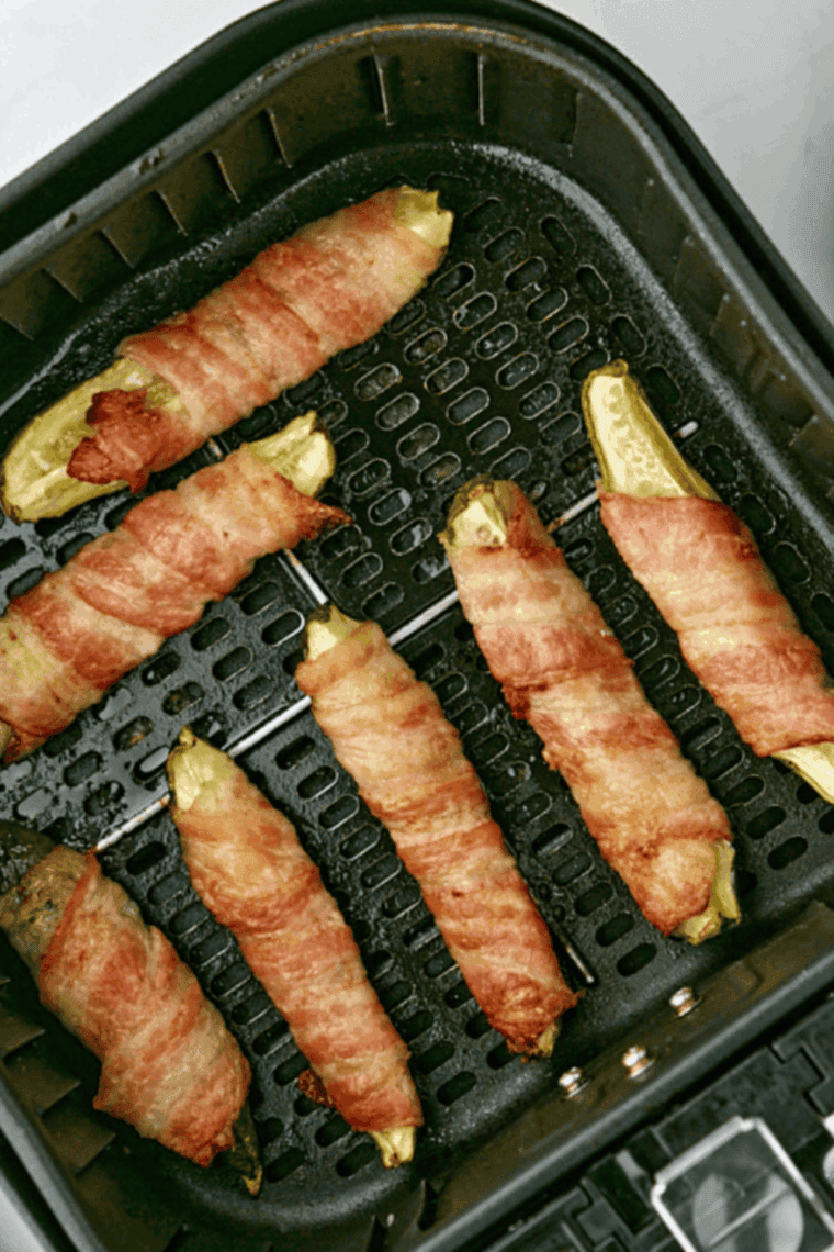 Air fryer bacon wrapped pickles cooked until bacon is crispy and golden