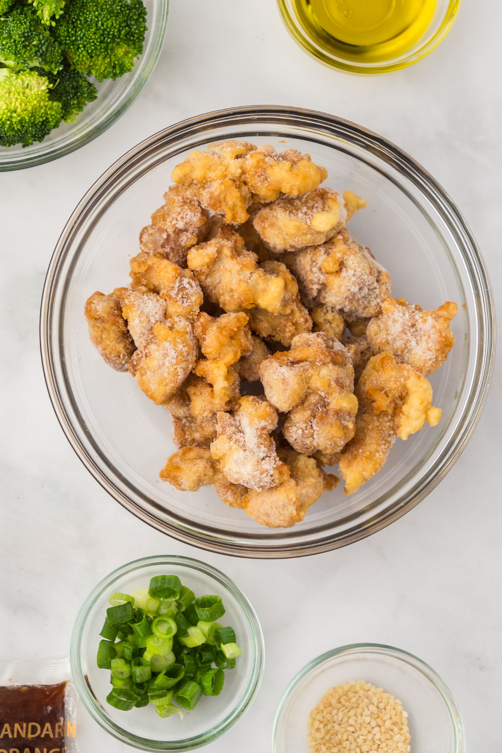 preheating air fryer and adding frozen orange chicken pieces in single layer