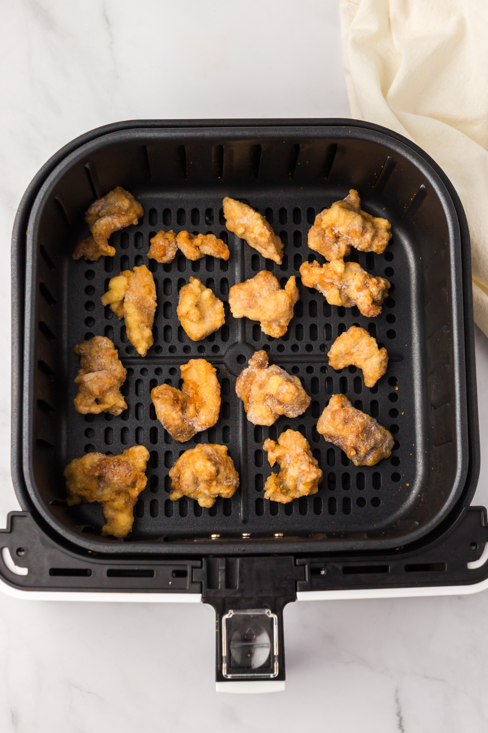 cooking frozen orange chicken in air fryer and shaking basket halfway through
