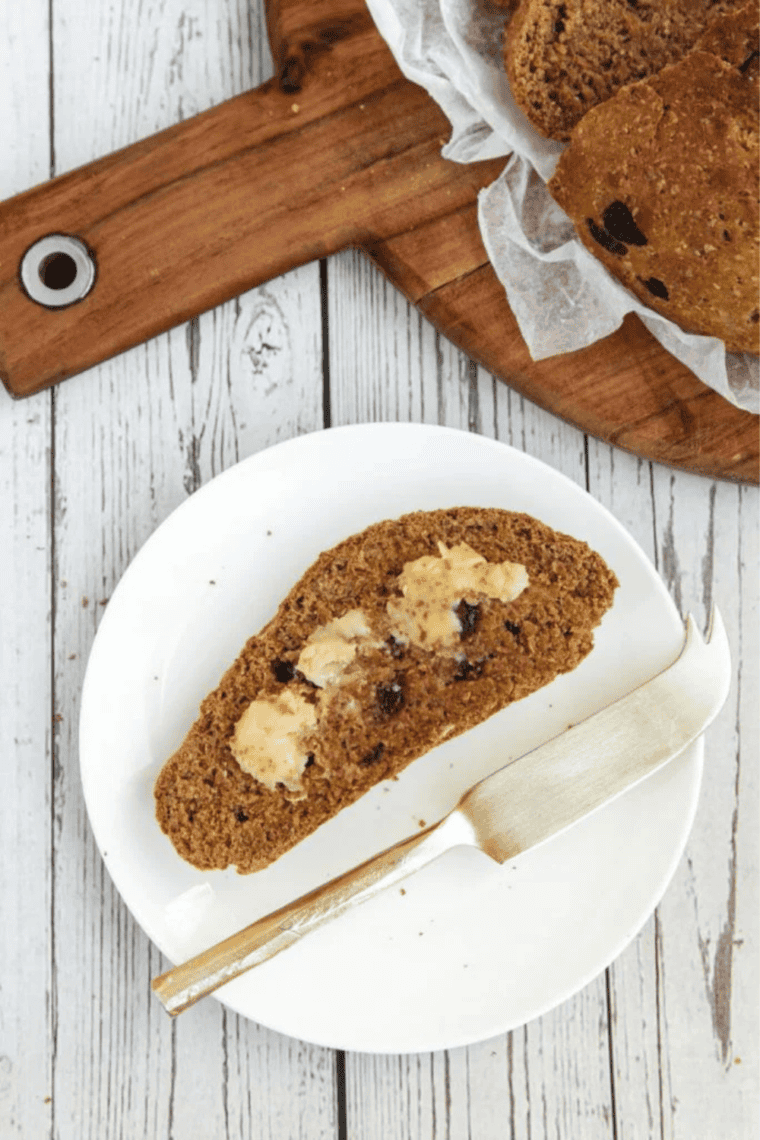 Sliced piece of air fryer Boston brown bread showing the moist, dense crumb with raisins