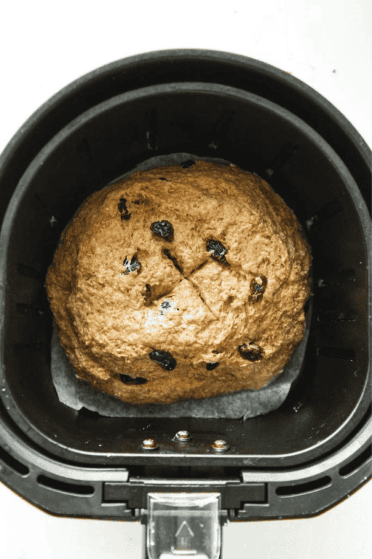 Shaping no-knead Boston brown bread dough into a rough round on a floured surface