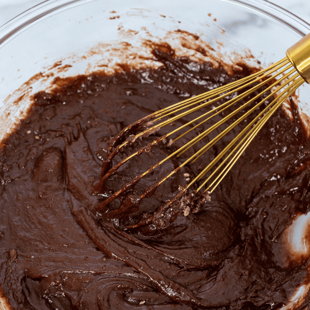 Mixing brownie mix, eggs, oil, and flour into thick cookie dough
